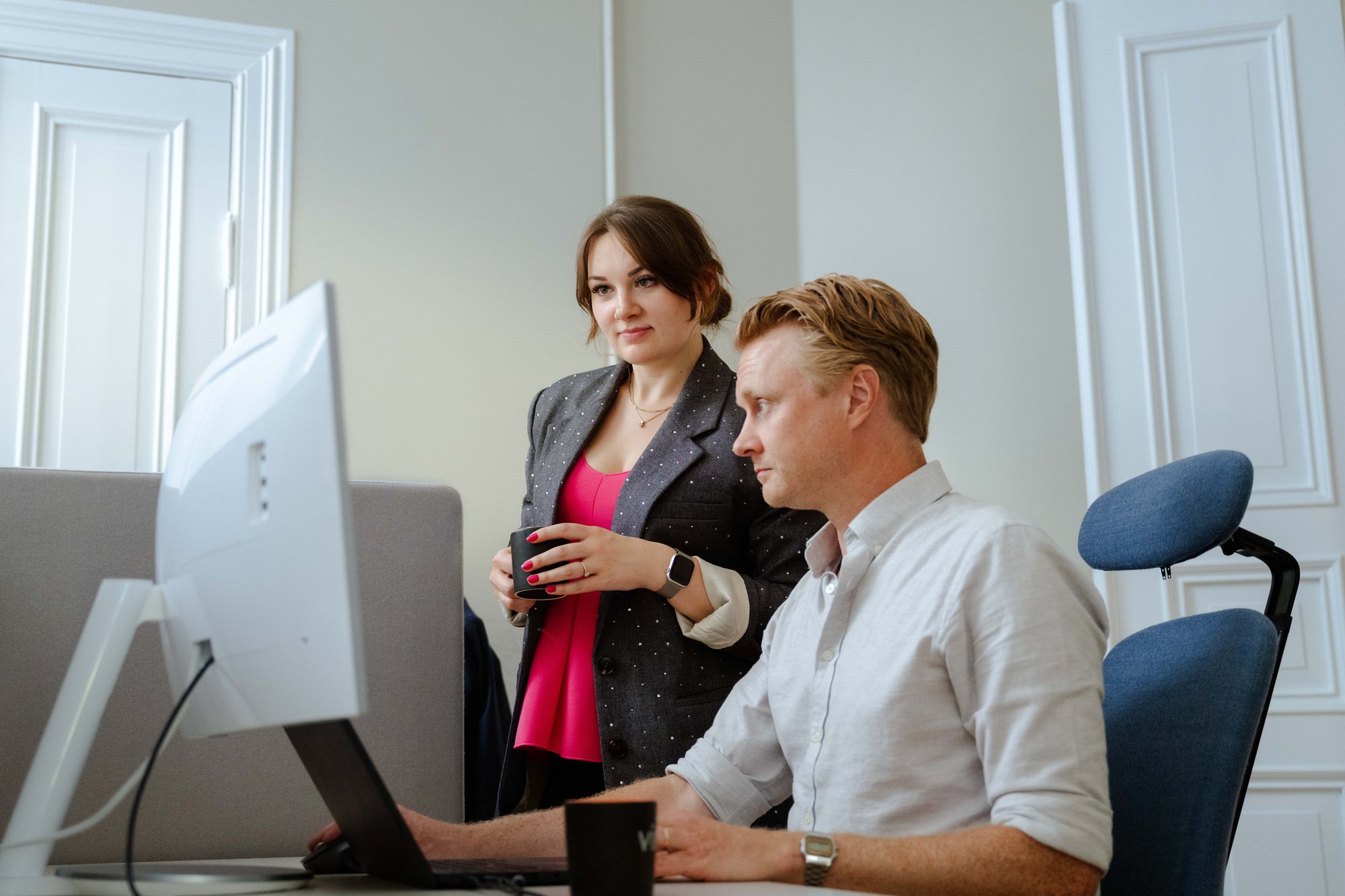 Man and woman looking at a screen